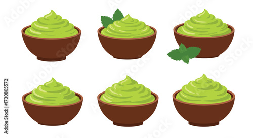 Six small bowls filled with vibrant green avocado cream and mint