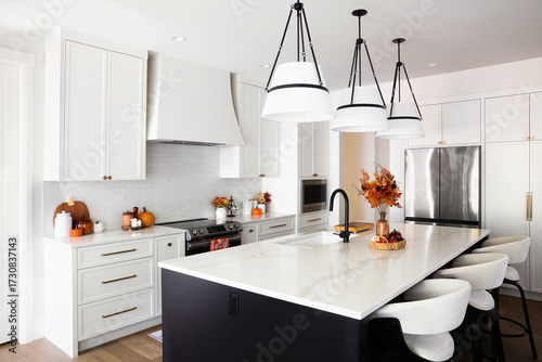 Beautiful modern kitchen with autumn cookware and decor display.