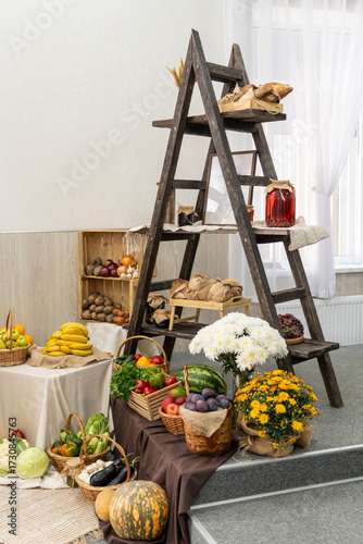 Wooden ladder display filled with fresh fruits, vegetables, and baked goods, showcasing a vibrant harvest arrangement in a cozy indoor setting with natural light