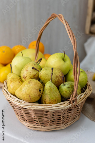 Fresh assortment of ripe pears in a woven basket, surrounded by vibrant oranges, showcasing natural colors and textures, perfect for healthy lifestyle concepts and culinary themes