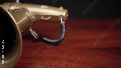 Vintage Brass Megaphone on Wooden Surface Close Up Shot.