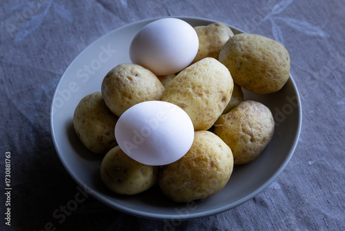 Eggs and boiled potatoes in a bowl in natural light