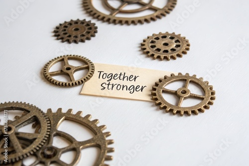 Brass gears arranged together on a white surface
