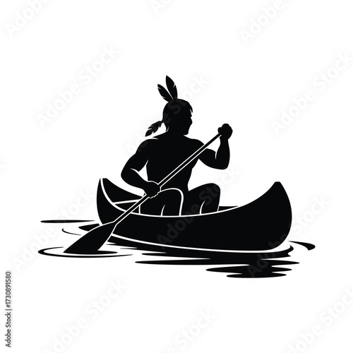 Native american man paddling a canoe in silhouette