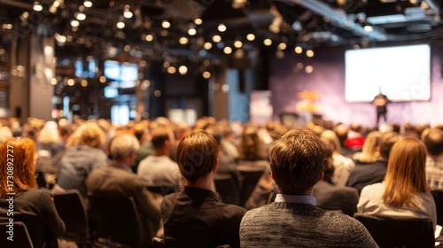 Business Conference with Audience Listening to Speaker on Stage