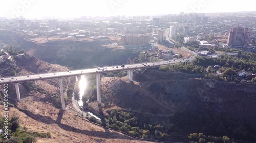 Drone view of a large bridge over a canyon connecting residential and industrial districts in Yerevan, Armenia.