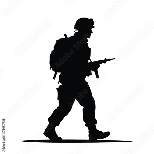 Silhouette of a soldier marching with a rifle in full combat gear ready for action