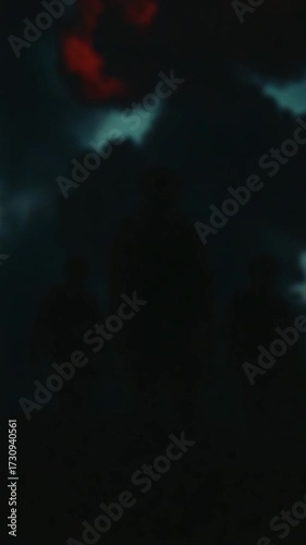 Silhouetted soldiers watch large explosion with orange and yellow colors