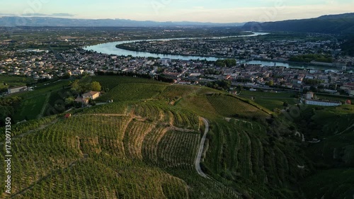 Aerial and scenic view of Tain Hermitage town with the winding Rhône River and lush vineyards at sunset in France’s renowned Rhone Valley wine region