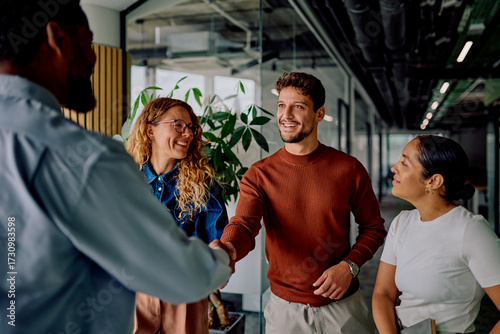 Konstfotografi Diverse business professionals smiling, shaking hands, and networking in a moder