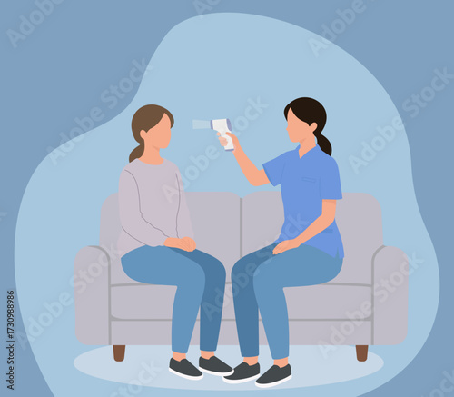 A healthcare worker checks a woman's temperature with a non-contact thermometer during a home visit, illustrating health screening and patient care
