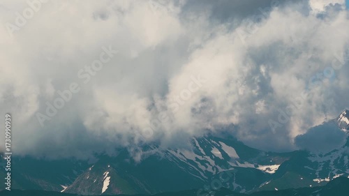 Beautiful mountain landscape. High-mountain massif, clouds over mountain peaks. Mountain slope inside a cloud, nature at a height