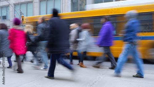 People with motion blur walking on a street sidewalk with a yellow bus passing by, showing urban movement and speed