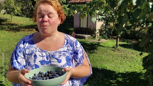 Female farmer tasting grapes in the garden