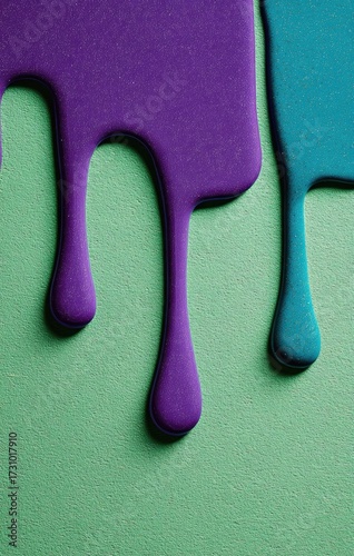 Close-up of dripping paint in vibrant purple and teal colors on a mint green background.  Viscous, glossy drips cascade downward, creating a dynamic texture
