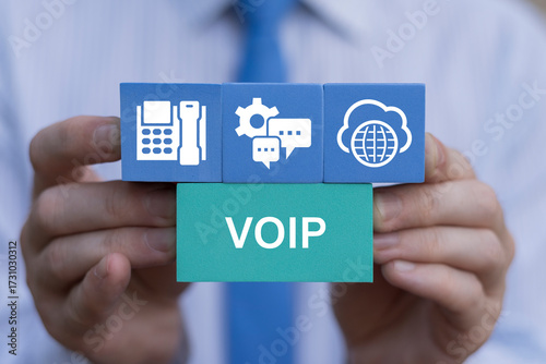 VOIP Telecommunication Technology concept. Business person holding styrofoam blocks with icons sees the acronym VOIP. IP Internet Protocol Telephony Connection Line.