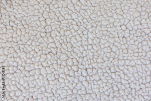 Macro texture of faux shearling fabric, soft fluffy textile background for winter fashion and design