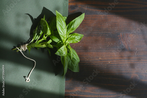 flatlay of fresh basil leaves on a dark background