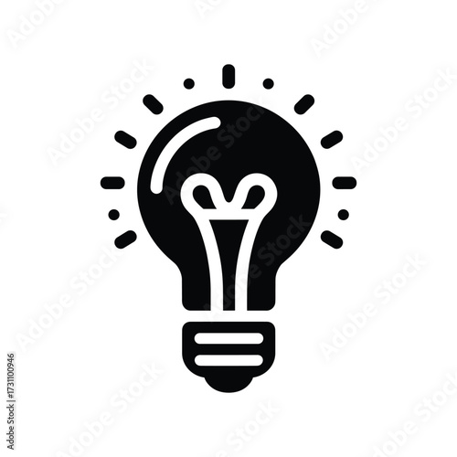 Light bulb glowing brightly against a dark background