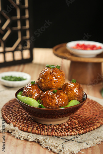 Chinese Lion's Head Meatballs - Traditional Braised Pork Specialty Dish with Bok Choy in Ceramic Bowl