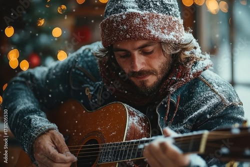 Man playing guitar in the snow.