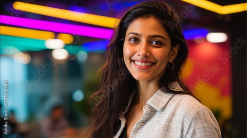 Confident and Happy Indian Woman with a Laptop in a Modern Office generative ai