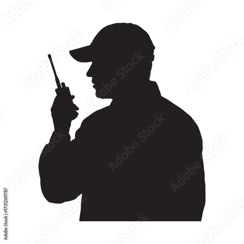 Silhouette security guard talking on radio at work