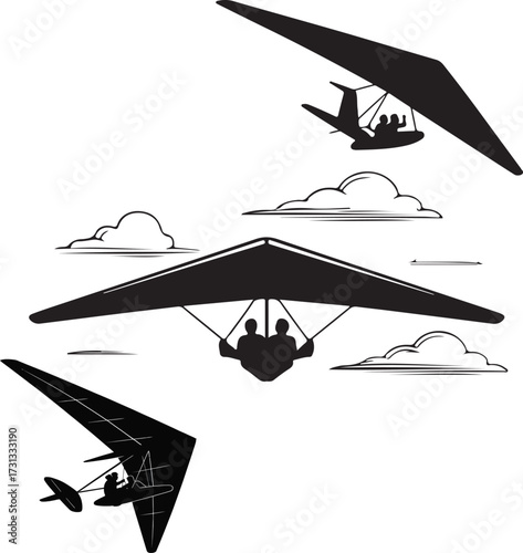 Three hang gliders soaring through the sky with clouds below