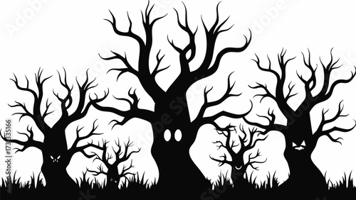 Silhouette of spooky trees with faces carved into the trunks in a halloween themed landscape design