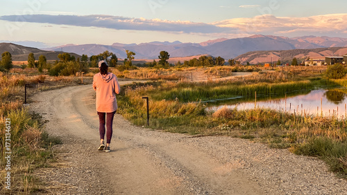 Woman Walking on Path in Granby Colorado and Rocky Mountains at Sunset