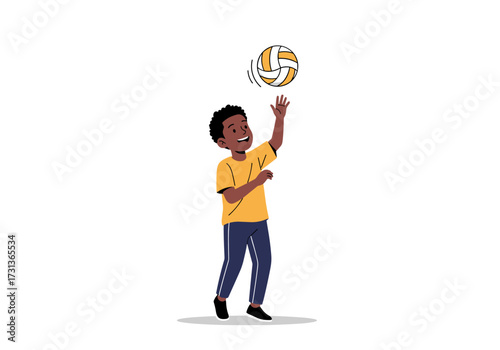 A young boy plays with a volleyball and tosses it up in the air.