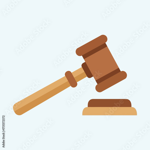 Wooden gavel and sound block on light blue background.