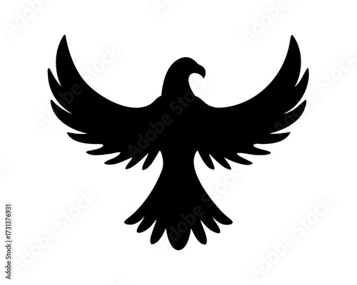 Black silhouette of a soaring bird of prey with spread wings