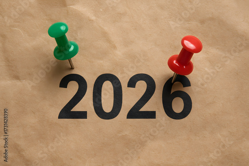 Year 2026 Marked with Green and Red Push Pins on Brown Paper