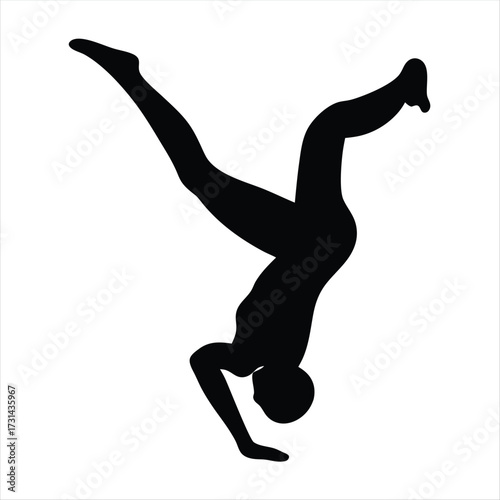 Silhouette of a person performing a complex acrobatic movement or dance
