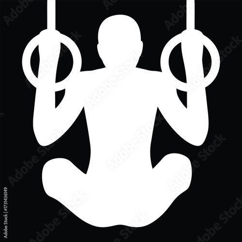 Silhouette of a male gymnast on rings, in midair position