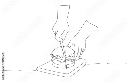 Continuous one line drawing of an act of cutting a burger in half, representing food preparation, dining moments, and culinary enjoyment, single line art.
