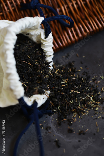 Wallpaper Mural Loose Leaf Tea Spilling from a Cloth Bag on Dark Surface with Rustic Texture Torontodigital.ca