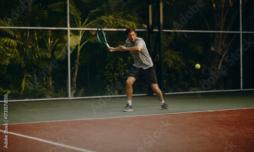 Male tennis player hitting a forehand