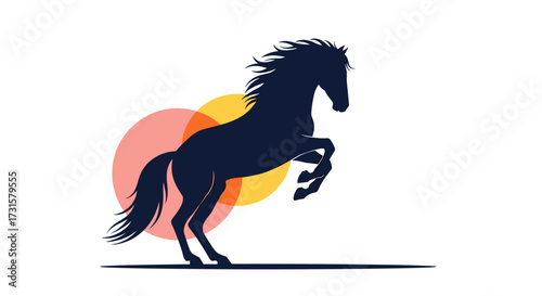 Silhouette of a powerful horse rearing up against a colorful sunset backdrop.