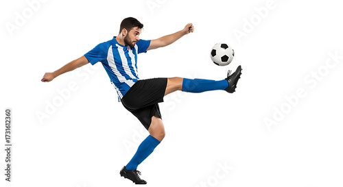 Soccer player kicking ball in mid air against black background
