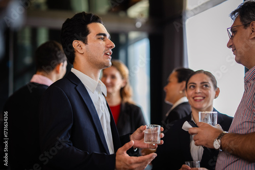 Professionals sharing insights during a corporate social gathering, emphasizing business relationships, communication, and organizational culture.