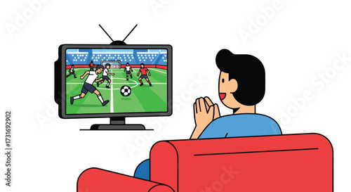 Excited fan watching a soccer game on tv from his red sofa during a tense moment of the match in anticipation and hope
