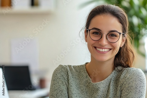 Happy young woman enjoys flexible work environment, confident professional radiates positivity in contemporary workspace