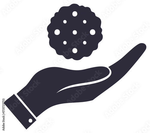 Dark Silhouette of a Hand Gently Holding a Cookie Above