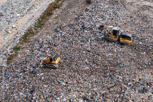 Arial view of excavator working with trash on rubbish dump