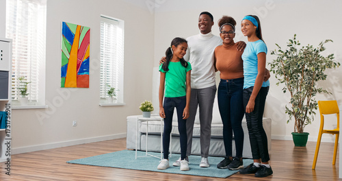 Canvas Print Surrounded by tasteful decor, a happy family embraces in their newly rented flat
