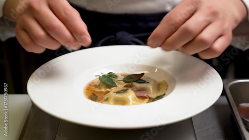 Professional Chef Artfully Plating Gourmet Handmade Ravioli with Sage and Butter Sauce