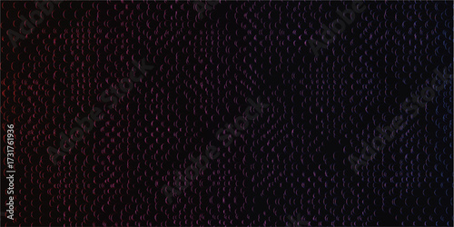 A close-up view of a dark, textured surface with subtle color variations.