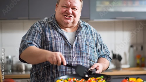A plus-size man cooks healthy food at home and speaks to the camera, sharing his wellness journey, positivity, and love for a balanced lifestyle.
